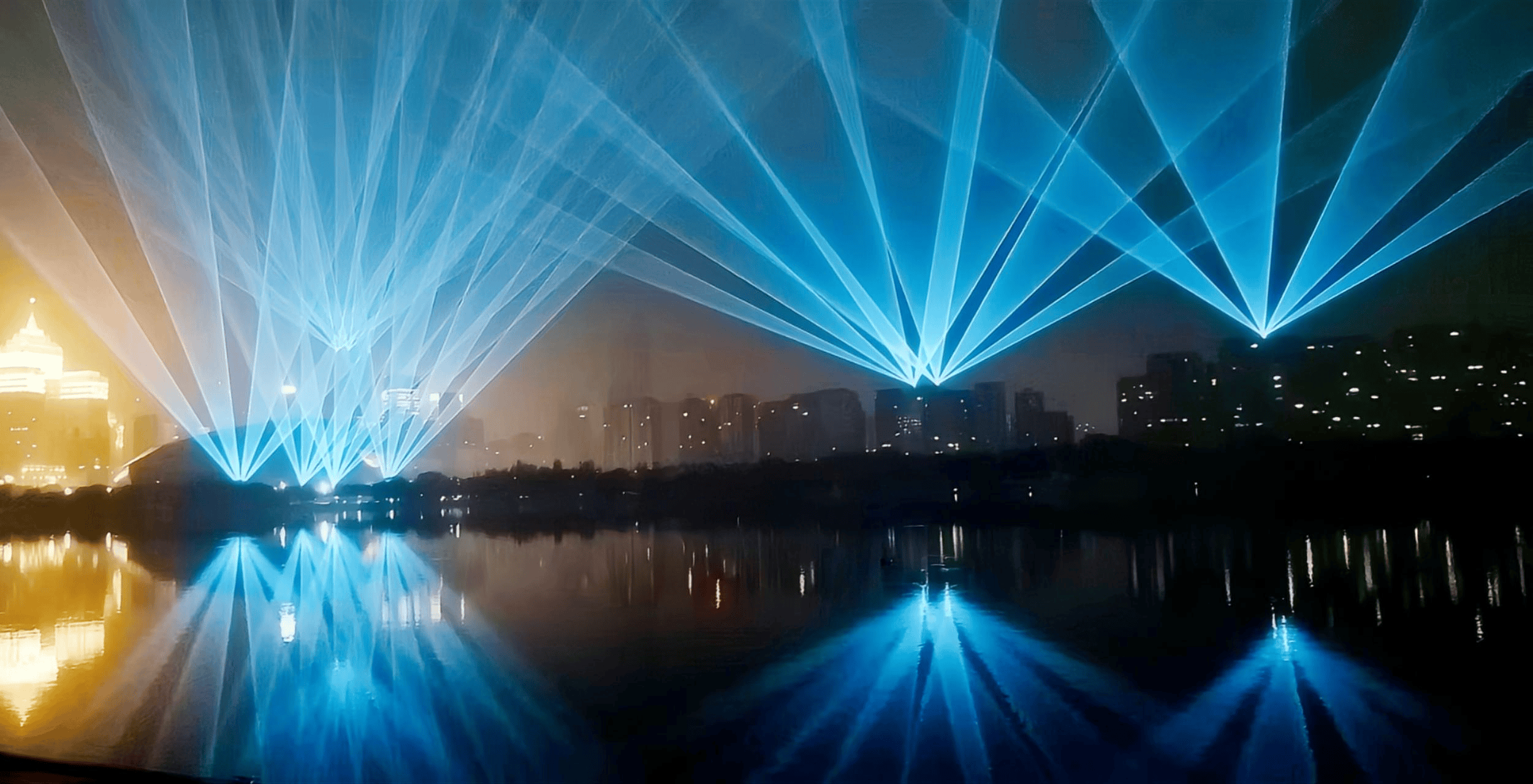 Blue laser beams illuminating the Shenyang Hunhe River waterfront and city skyline at night URL	shenyang-hunhe-river-laser-show