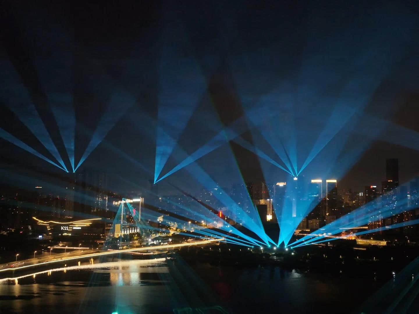 Blue laser beams illuminating the Shenyang Hunhe River waterfront and city skyline at night URL	shenyang-hunhe-river-laser-show