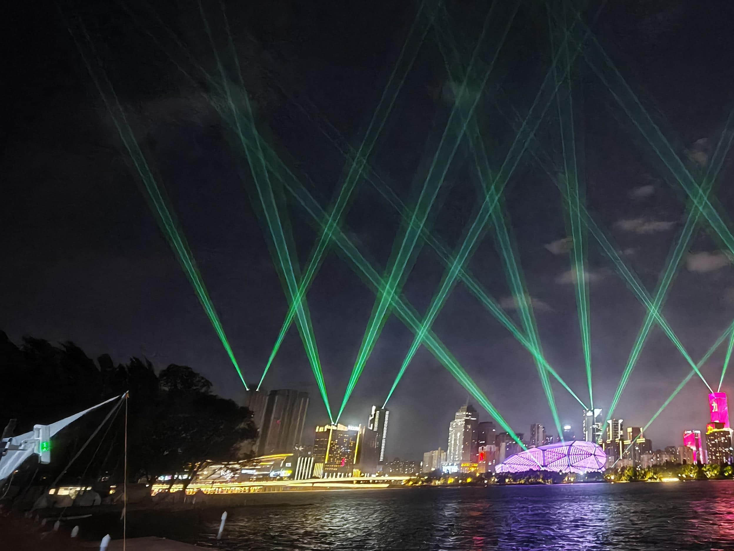 Blue laser beams illuminating the Shenyang Hunhe River waterfront and city skyline at night URL	shenyang-hunhe-river-laser-show