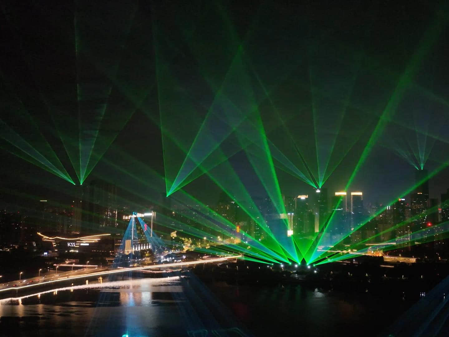 Blue laser beams illuminating the Shenyang Hunhe River waterfront and city skyline at night URL	shenyang-hunhe-river-laser-show