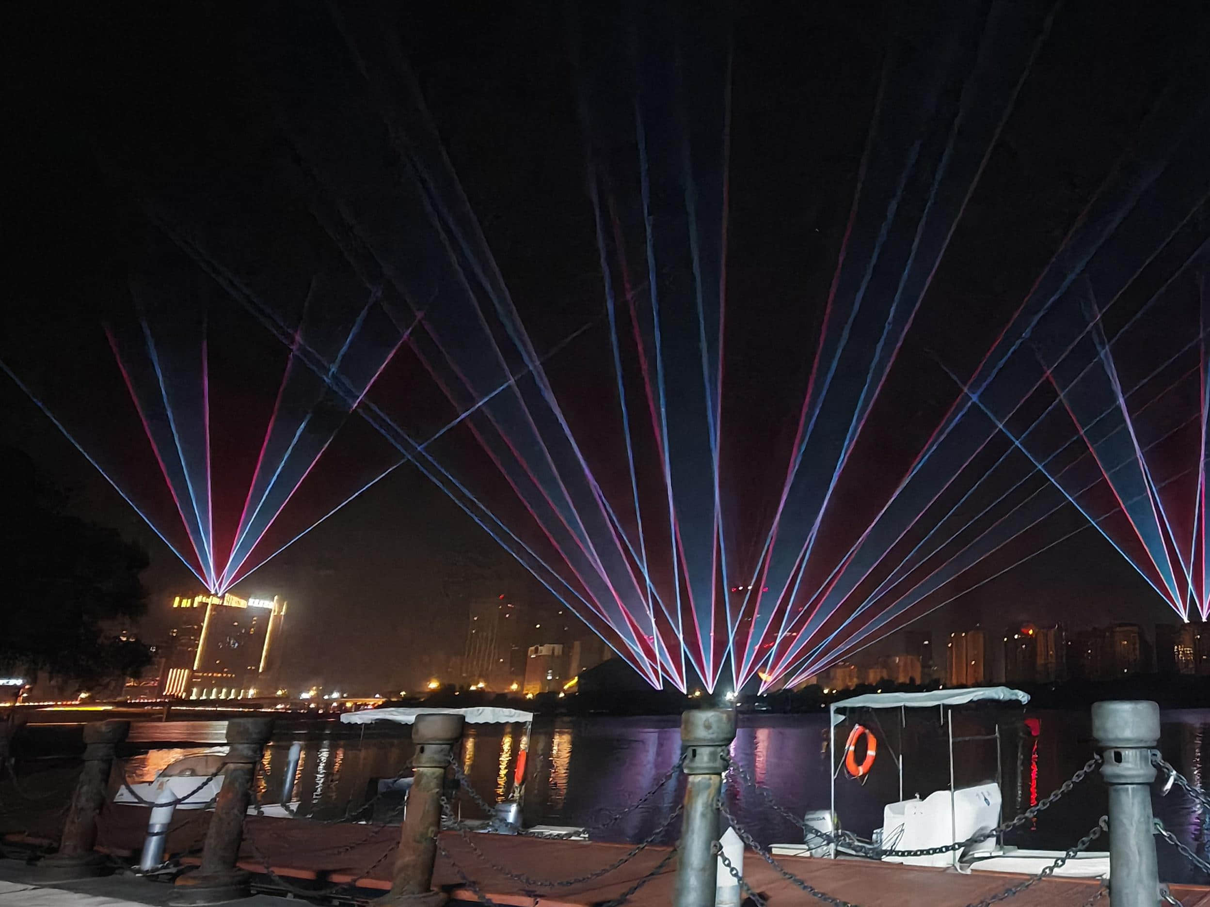 Blue laser beams illuminating the Shenyang Hunhe River waterfront and city skyline at night URL	shenyang-hunhe-river-laser-show