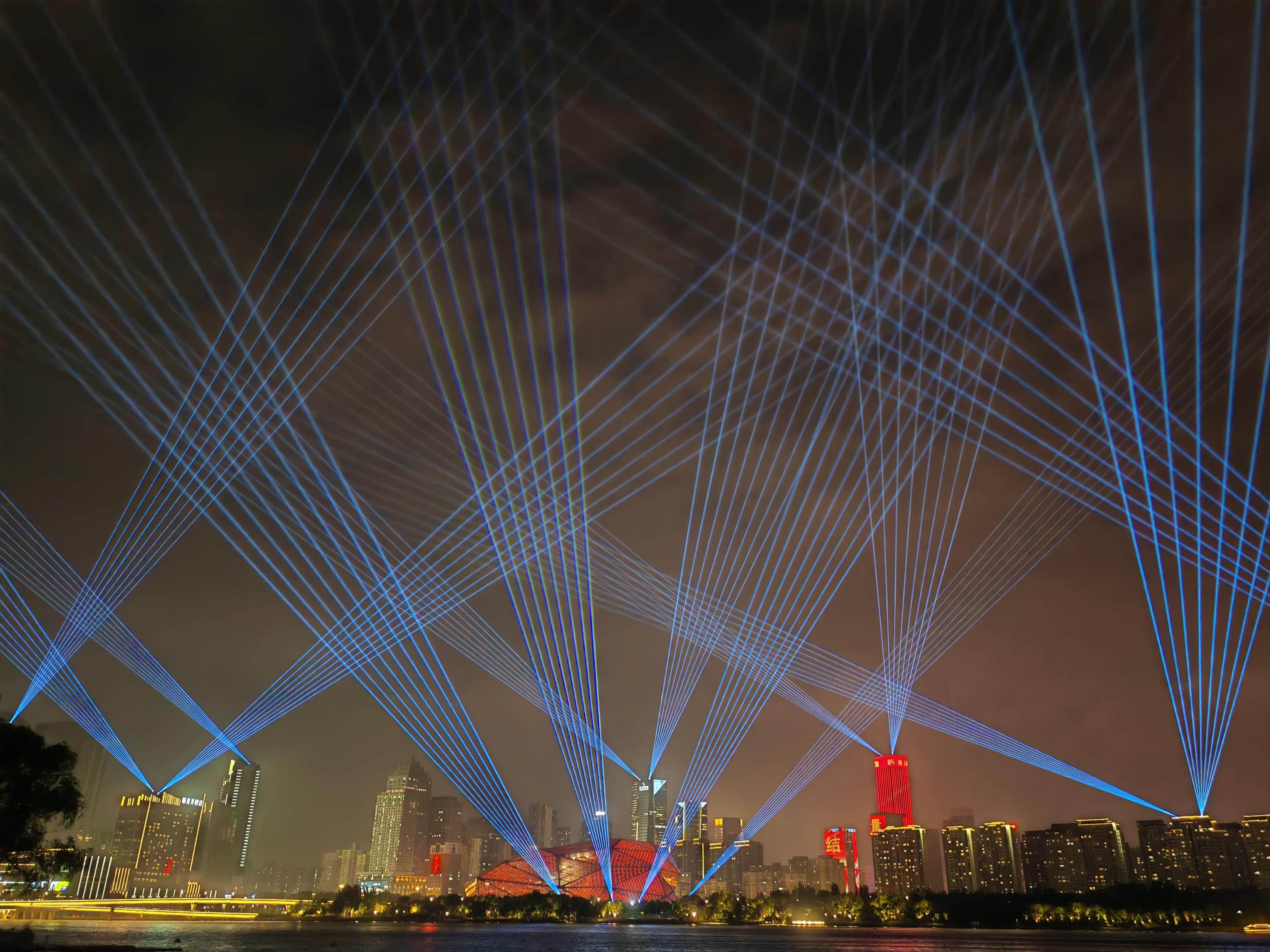 Blue laser beams illuminating the Shenyang Hunhe River waterfront and city skyline at night URL	shenyang-hunhe-river-laser-show