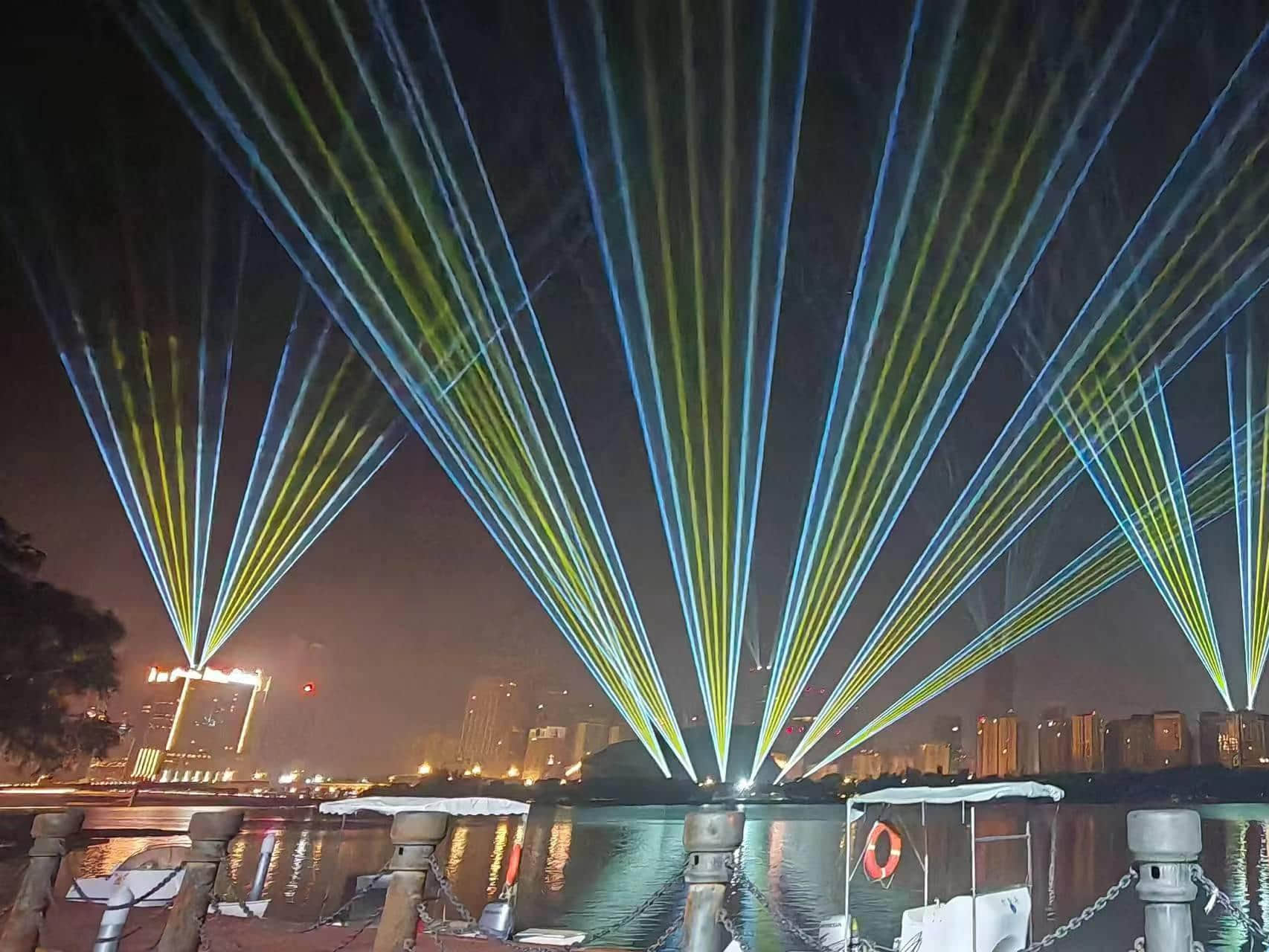 Blue laser beams illuminating the Shenyang Hunhe River waterfront and city skyline at night URL	shenyang-hunhe-river-laser-show