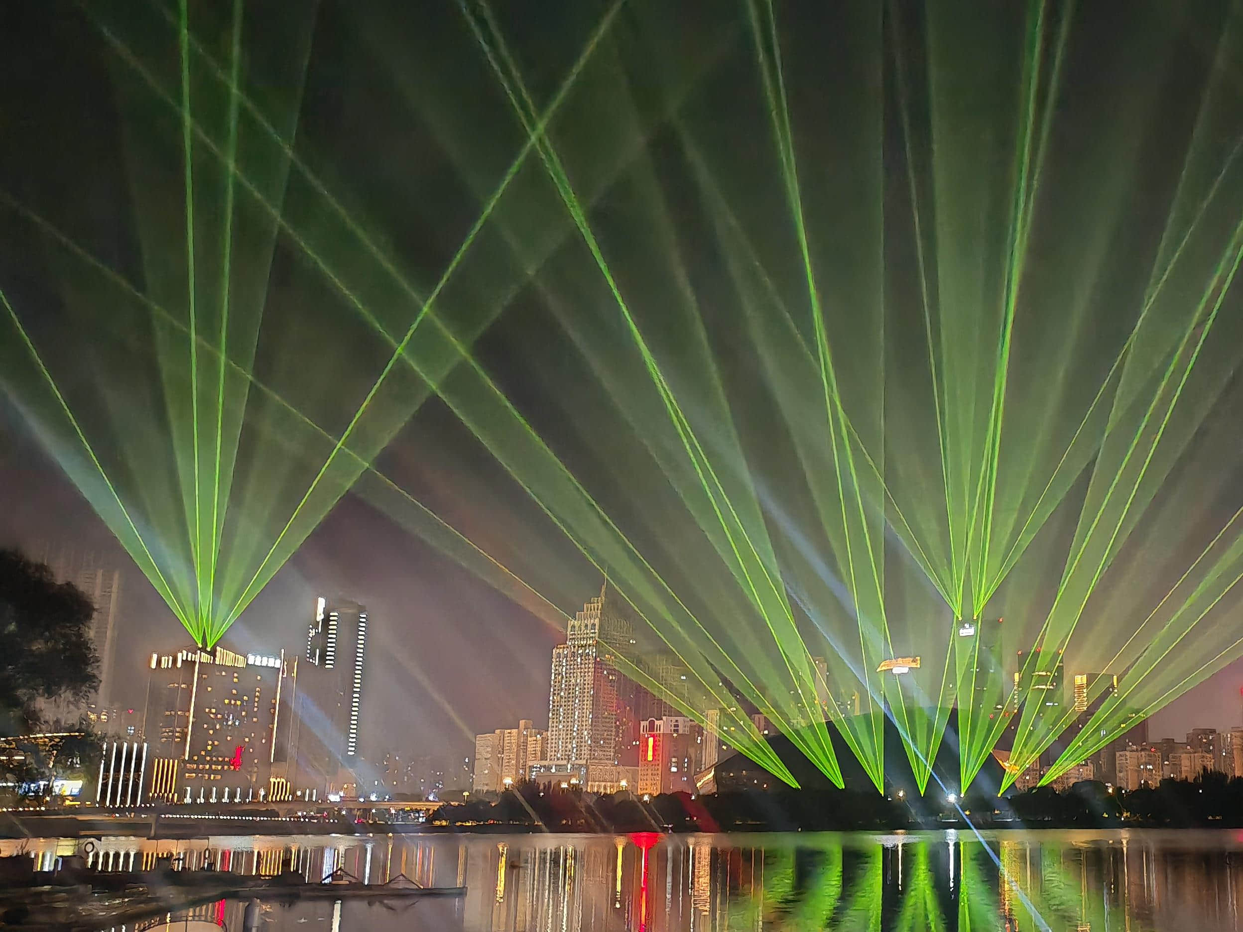 Blue laser beams illuminating the Shenyang Hunhe River waterfront and city skyline at night URL	shenyang-hunhe-river-laser-show