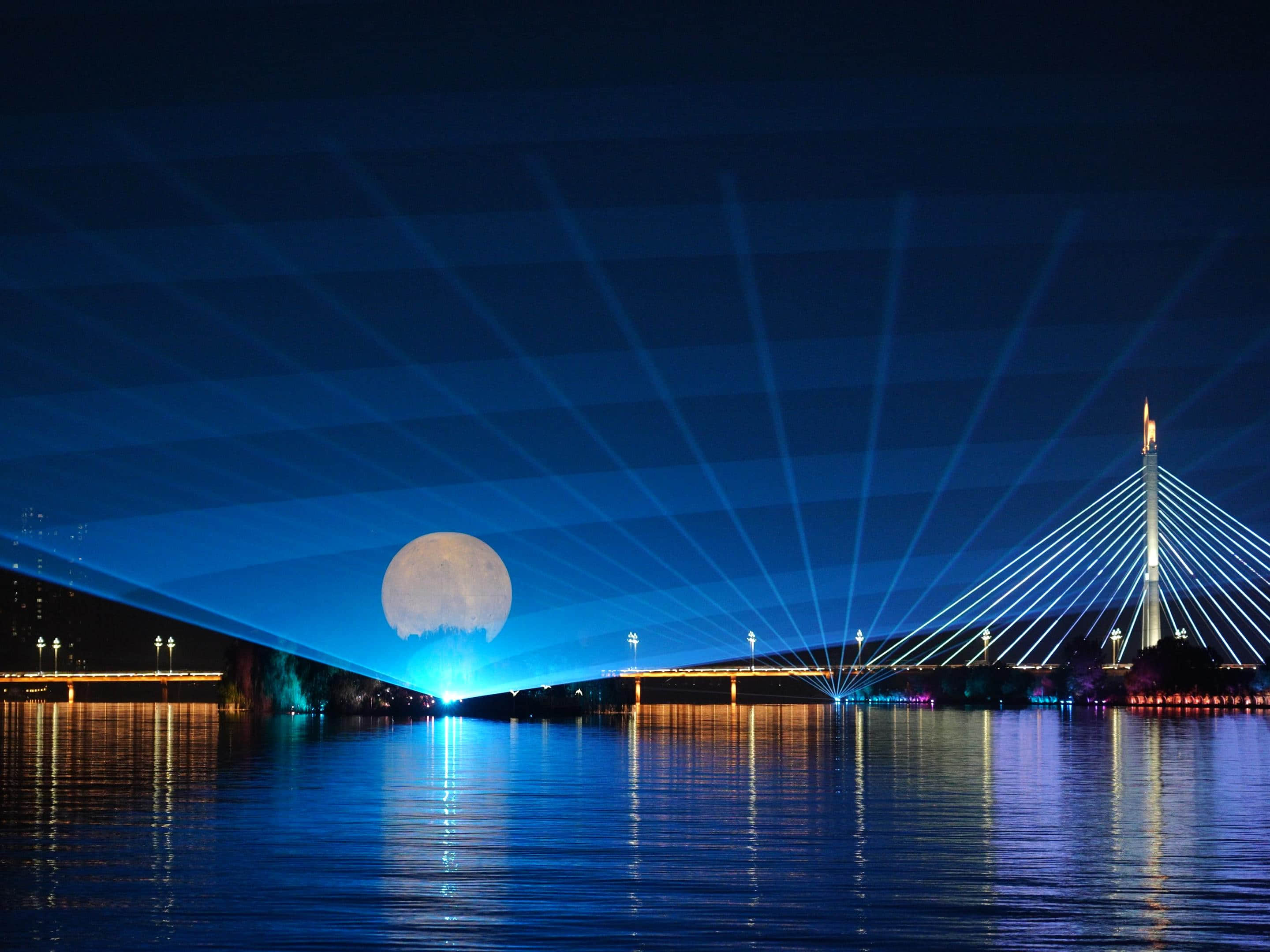 Xianyang Gudu Covered Bridge nighttime laser show featuring waterfront lighting, colorful laser beams and water effects