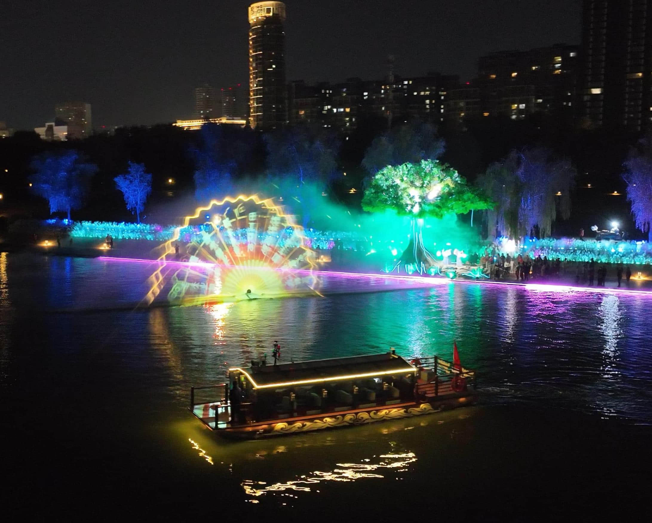 Xianyang Gudu Covered Bridge nighttime laser show featuring waterfront lighting, colorful laser beams and water effects