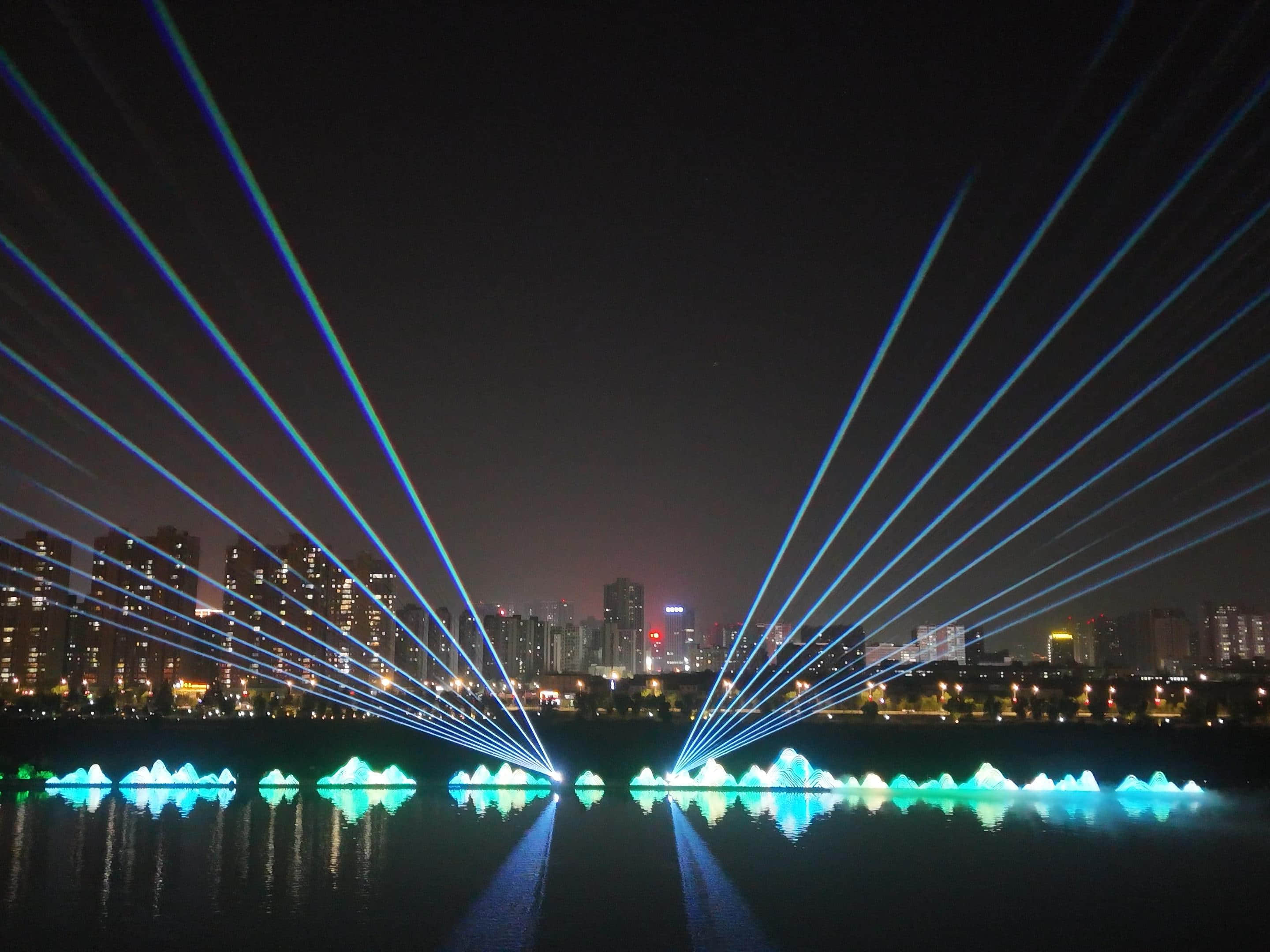 Xianyang Gudu Covered Bridge nighttime laser show featuring waterfront lighting, colorful laser beams and water effects