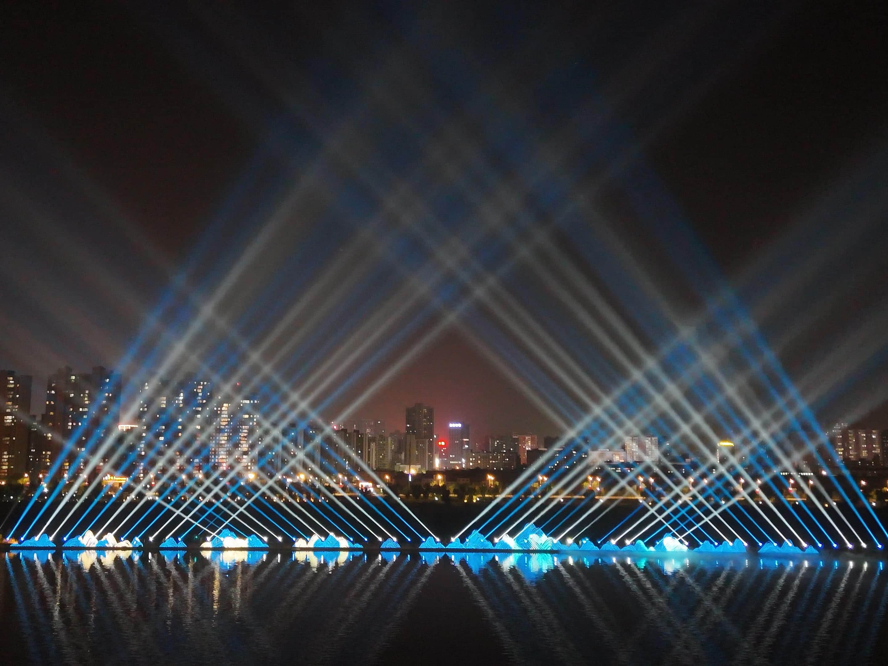 Xianyang Gudu Covered Bridge nighttime laser show featuring waterfront lighting, colorful laser beams and water effects