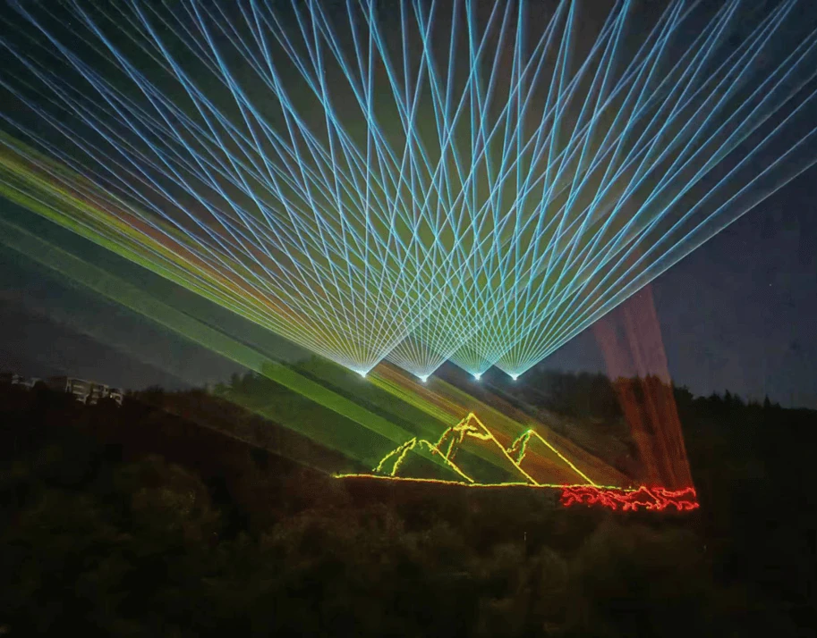 Green laser beams illuminating a mountain landmark at night in Yima, Henan Green laser beams illuminating a mountain landmark at night in Yima, Henan