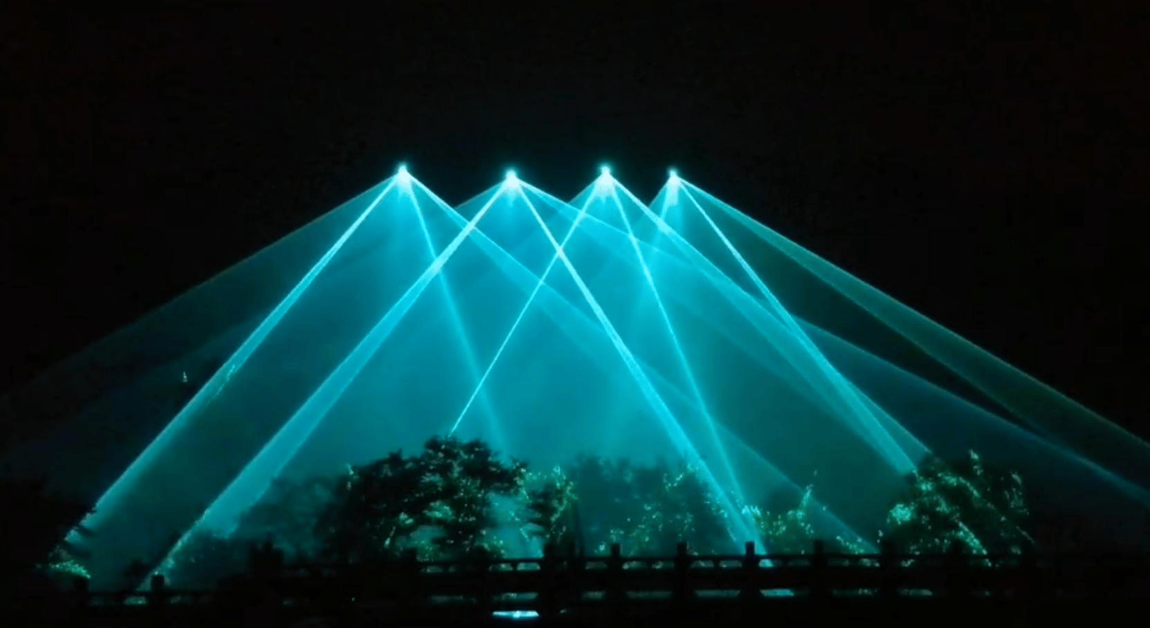 Green laser beams illuminating a mountain landmark at night in Yima, Henan Green laser beams illuminating a mountain landmark at night in Yima, Henan