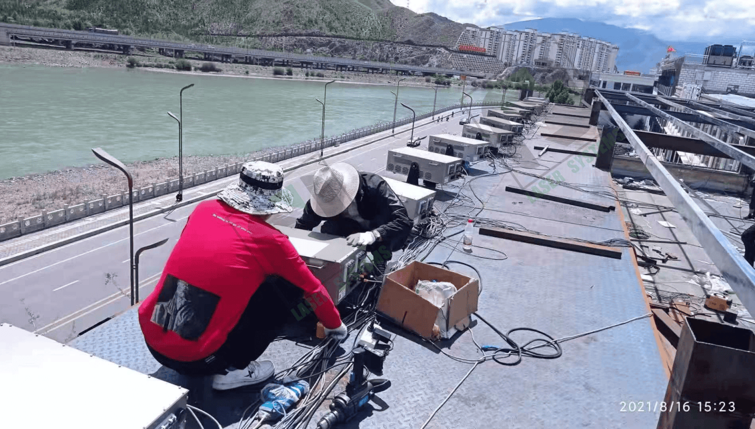 Outdoor laser text projection illuminating a mountainside during the Tibet anniversary celebrations