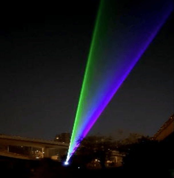 Green and purple outdoor laser beams extending into the night sky in Zhengzhou