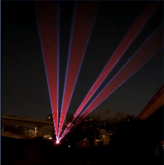 Green and purple outdoor laser beams extending into the night sky in Zhengzhou
