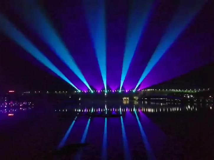 Rainbow-shaped colorful lighting reflected on the water during the Danjiangkou laser show in Shiyan, Hubei, China Rainbow-shaped colorful lighting reflected on the water during the Danjiangkou laser show in Shiyan, Hubei, China