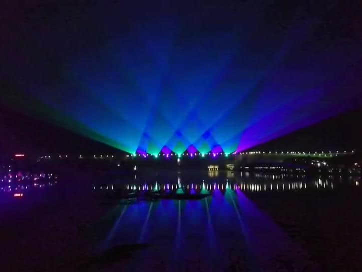 Rainbow-shaped colorful lighting reflected on the water during the Danjiangkou laser show in Shiyan, Hubei, China Rainbow-shaped colorful lighting reflected on the water during the Danjiangkou laser show in Shiyan, Hubei, China