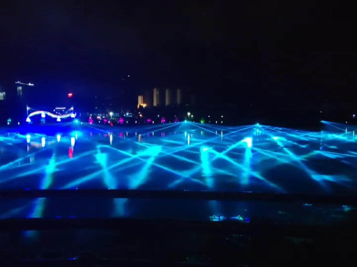 Rainbow-shaped colorful lighting reflected on the water during the Danjiangkou laser show in Shiyan, Hubei, China Rainbow-shaped colorful lighting reflected on the water during the Danjiangkou laser show in Shiyan, Hubei, China