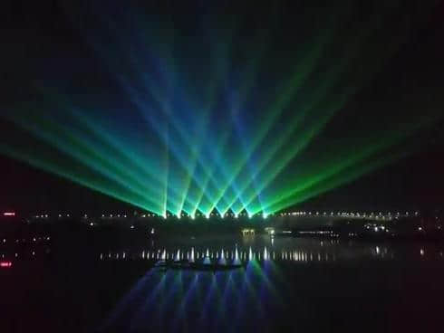 Rainbow-shaped colorful lighting reflected on the water during the Danjiangkou laser show in Shiyan, Hubei, China Rainbow-shaped colorful lighting reflected on the water during the Danjiangkou laser show in Shiyan, Hubei, China
