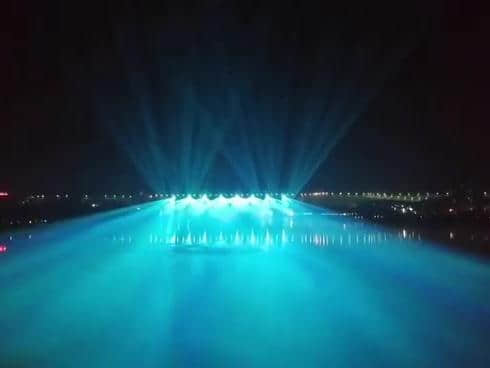 Rainbow-shaped colorful lighting reflected on the water during the Danjiangkou laser show in Shiyan, Hubei, China Rainbow-shaped colorful lighting reflected on the water during the Danjiangkou laser show in Shiyan, Hubei, China