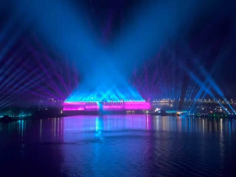 Rainbow-shaped colorful lighting reflected on the water during the Danjiangkou laser show in Shiyan, Hubei, China Rainbow-shaped colorful lighting reflected on the water during the Danjiangkou laser show in Shiyan, Hubei, China