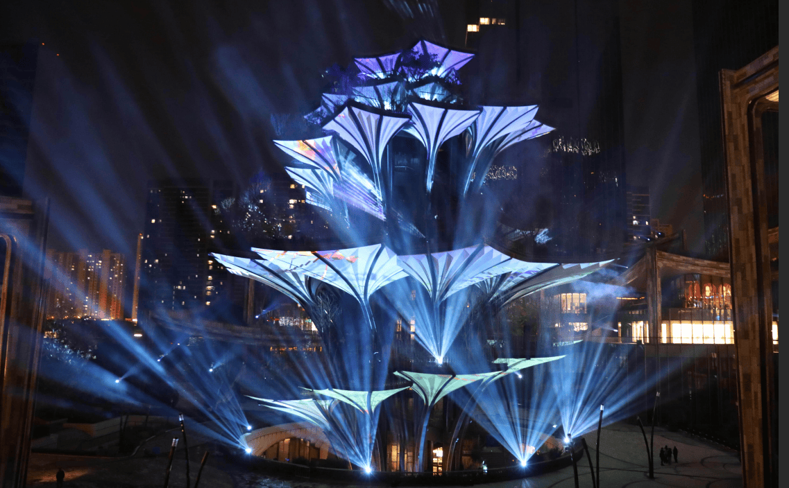 Purple laser beams creating intersecting patterns around the Tree of Life landmark installation in Xi'an, China Purple laser beams creating intersecting patterns around the Tree of Life landmark installation in Xi'an, China